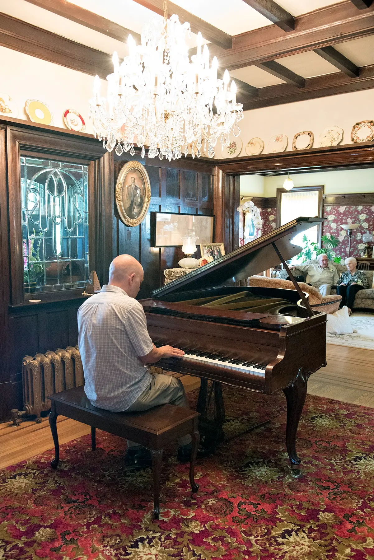 Paul playing a grand piano in an intimate heritage interior